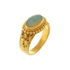 This charming 24k yellow gold ring features a 9 x 6mm oval opal, approximately 0.75ct in size, bezel set in East-West direction. This opal is free of fractures and has a high color intensity of green and blue with lots of flashfire. Polish is good to fair. The sides of the ring are embellished with gold beading and a raised detailed floral leaf motif that runs along the sides of the shank.  The ring measures 6.7mm at the top of the shank and tapers to 3.47mm at the base. The opal rises 4.4mm above the finger. The rich gold color of the 24k matched with the green/blue opal makes for an alluring combination. -  Opal: 1/ 9 x 6 x 2.3mm oval cabochon, free of fractures, high color intensity, flashfire, good cut, good to fair polish  -  Ring Width: 6.7mm graduates to 3.47mm at base -  Size:  4.5 Luxury Opal Ring With Oval Cabochon, Luxury Classic Opal Ring Oval Cabochon, Oval Opal Ring, Leaf Motif, Oval Rings, Opal Ring, Yellow Gold Ring, East West, Oval Cabochon