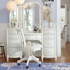 a white desk with a chair and mirror