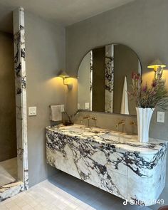 a bathroom with marble counter tops and mirrors