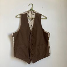 Neat moleskin vest, not sure of age. 1940s in style but possibly made later.  Great condition. Underarm to Underarm: 22" Length: 24.5" Please ask any questions before purchasing, especially concerning fit or condition. All items are vintage and in condition as described. Shipping via USPS unless otherwise agreed upon. All sales final, no returns- Thank You from Collecting Dust! Retro Brown Cotton Vest, Classic Brown Cotton Vest, Vintage Workwear Vest With Pockets, Vintage Vest With Pockets For Work, Retro Brown Vest For Workwear, Retro Brown Vest For Work, Vintage Vest With Pockets, Vintage Brown Cotton Vest, Retro Sleeveless Vest For Work