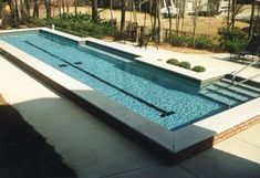 an empty swimming pool with steps leading up to it