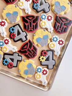 decorated cookies in the shape of numbers on a cookie sheet