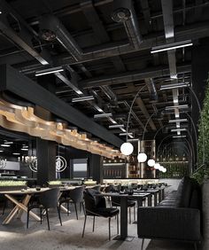 an empty restaurant with black chairs and tables