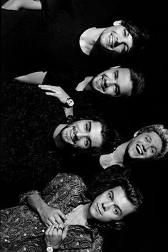 four men are posing for a black and white photo