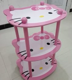 a pink hello kitty shelf on the floor