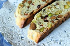 two slices of bread with nuts on a doily