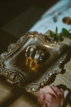 two wedding rings sitting on top of a tray