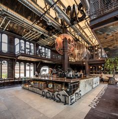 the inside of a building with lots of windows and graffiti on the walls, along with an open bar