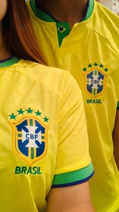 two women in yellow soccer uniforms are posing for the camera with their hands on their hips