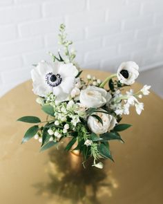 Freshest in the first 1-3 days. See Longevity Notes. Arrives arranged in vase with water. Features This item is a set. Here is what you will receive: - 5 small floral arrangements Set the table in style with our beautiful floral arrangement set! In shades of white, cream and black these small arrangements include garden roses, anemones and delphinium to create a truly one of a kind look. Your table will blossom! Place these along your dining table, around the bar or on highboys to dress up any space. This arrangement is Ready-To-Party™. Comes watered and arranged. Simply unbox and enjoy! * Designed with your event in mind, flowers are at their peak bloom on the day of your event. Longevity may vary based on temperature, environment and handling. Florals should avoid direct sunlight. Water White And Cream Flower Arrangements, Small White Floral Arrangements, White Anemone Centerpiece, White Florals, Anemone Centerpiece, White Floral Centerpieces, White Floral Arrangements, Small Centerpieces, White Anemone