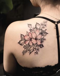 a woman with a flower tattoo on her back