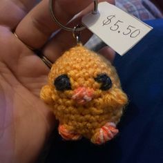 a small yellow bird keychain with a price tag on it's back