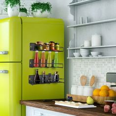 a green refrigerator freezer sitting inside of a kitchen