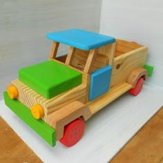 a wooden toy truck sitting on top of a table