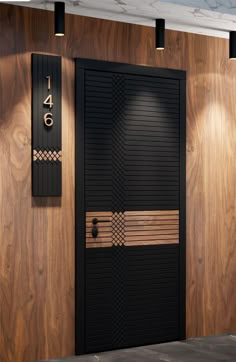 a black and gold door is in front of a wooden wall with numbers on it