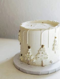 a white frosted cake sitting on top of a table