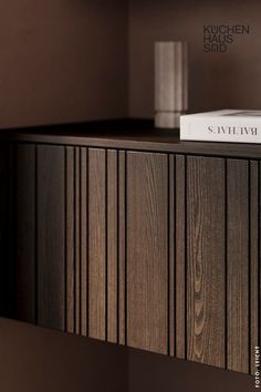 a book sitting on top of a wooden shelf