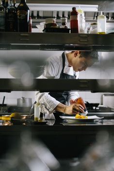 a chef is preparing food in the kitchen