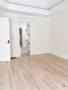 an empty room with hard wood flooring and white paint on the walls is shown