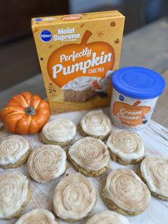 some cupcakes are sitting on a table next to a carton of pumpkin spice