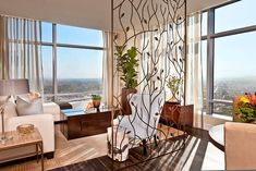 a living room filled with furniture and large windows