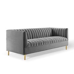 a grey velvet couch with gold legs on an isolated white background, viewed from the front