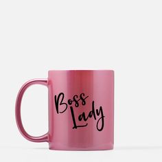 a pink coffee mug with the words boss lady printed in black on it's side