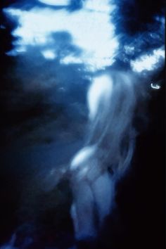 a blurry image of a person standing in the dark