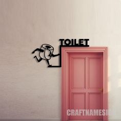 a pink door is in front of a white wall with a sign that says toilet