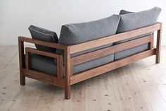 a couch sitting on top of a hard wood floor