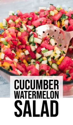 watermelon salad in a glass bowl with a wooden spoon and text overlay reading cucumber watermelon salad