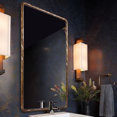 a bathroom sink under a large mirror next to a wall mounted light and two lamps