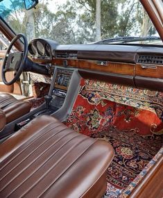 the interior of an old car with leather seats and carpeted flooring, including a dash board