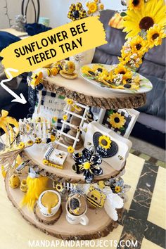 a tiered tray with sunflowers and other items on it