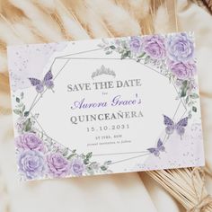 save the date card with purple flowers and butterflies on it, surrounded by feathers in front of a white background