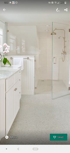 a large bathroom with white fixtures and green accents