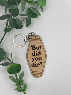 a wooden keychain that says, but did you die?