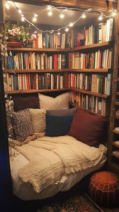 a bed with lots of books on the shelves