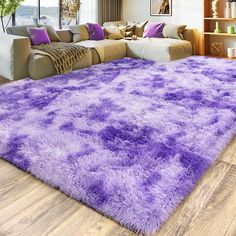 a living room with a large purple rug on the floor