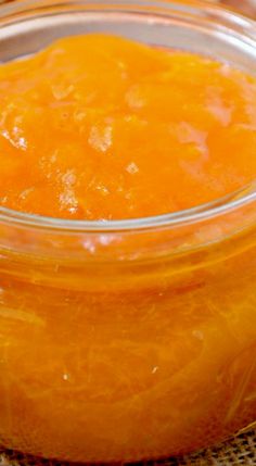 a jar filled with oranges sitting on top of a table