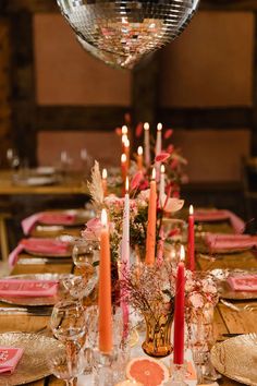 a long table with candles and plates on it