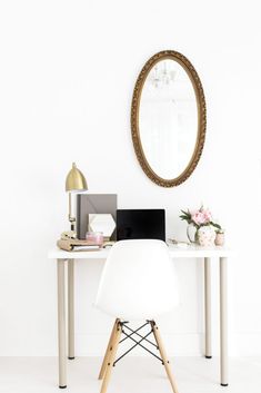 a white desk with a mirror on the wall