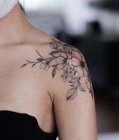 a woman with a flower tattoo on her shoulder