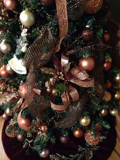 a christmas tree decorated with ornaments and ribbons