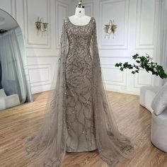 a dress is displayed on a mannequin in a room with white walls and wooden floors