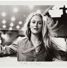 a black and white photo of a woman with long hair