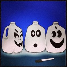 three plastic jugs with faces drawn on them