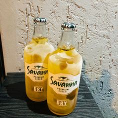 two bottles of saunana are sitting on a table