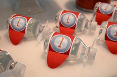 red and white candy cups with the letter i on them are lined up in rows