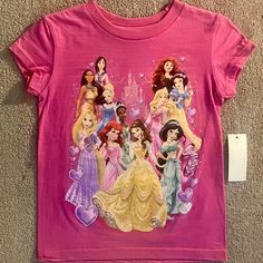 This Adorable Disney Princess T-Shirt Is Perfect For Your Little Girl! Featuring Tiana And Ariel, This Xxs (2/3) Size T-Shirt Comes In A Beautiful Shade Of Pink That Your Little Princess Will Love. Made From High-Quality Materials, This T-Shirt Is Both Comfortable And Durable, Making It Perfect For Everyday Wear. The T-Shirt Is Suitable For Baby And Toddler Girls And Is Part Of Our Baby & Toddler Clothing Collection. It Is A Great Addition To Your Daughter's Wardrobe Or A Thoughtful Gift For A L Pink Cartoon Print Top For Disney Fan Events, Pink Disney Character Print T-shirt, Pink Disney Short Sleeve T-shirt, Disney Pink Tops With Character Print, Fitted Pink T-shirt With Character Print, Tiana And Ariel, Disney Princess Shirt, Disney Princess Toddler, Disney Princess Babies